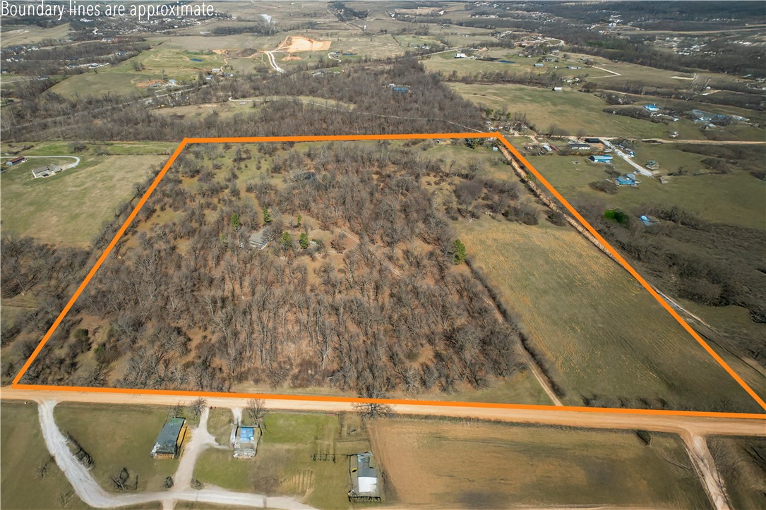 A developer's dream nestled in Bentonville on 13.46 acres in the heart of nature and in Bentonville school district. A fixer upper with substantial potential for modernization and transformation to match its breathtaking surroundings. Many open spaces welcome endless possibilities for development or renovation including a bonus room and a cozy fireplace, all ready to be updated. With expansive land at your disposal, there's ample room for expansion or creating new structures to enhance this country setting.