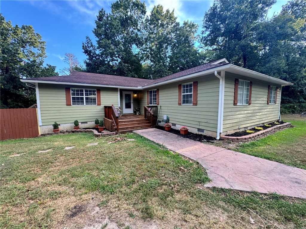 Charming ranch style home sitting on over 3 acres with large detached garage. The concrete pad beside the garage for RV parking. This 4 BR 2 full bathrooms in this beautifully maintained home features large living room with a wood fireplace. Kitchen has bar that sits 2-3 people. Primary Suite offers walk in closet leading to the ensuite bath. Ample space for the growing family or the person that needs an office. Property has two outside storage buildings. There is a two car, detached garage w a gravel driveway leading up to the home.