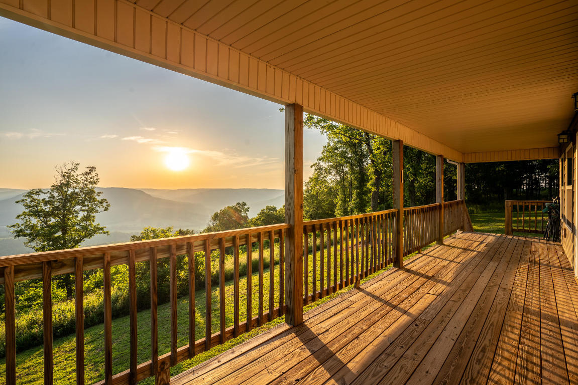 This stunning 1-bedroom home boasts captivating views from almost every room, making it the perfect escape for nature lovers. Enjoy the panoramic beauty of the Ozark Mountains and valleys, right from the expansive deck that runs the entire length of the house. This charming home offers the perfect blend of comfort and convenience. Enjoy amenities of a newer home, including a new addition in 2024 and a carport added in 2023.The private subdivision offers a peaceful retreat, nestled amongst towering trees and breathtaking scenery. The home sits at the end of a cul-de-sac, ensuring some of the best views in the area, ultimate privacy and tranquility.