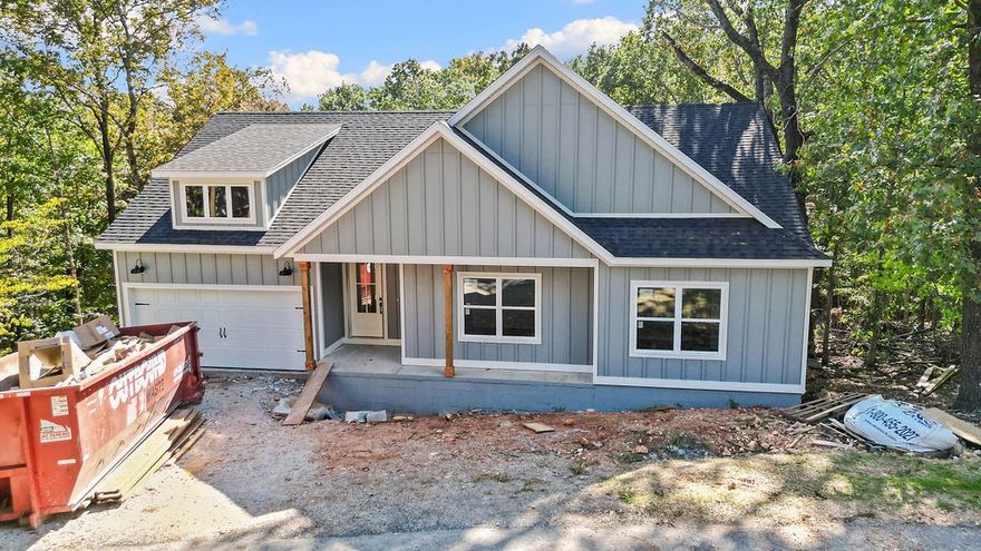This stunning home showcases 7" hand-scraped engineered wood floors throughout—including closets—and stylish tile in the laundry and baths. The inviting living area features an electric fireplace accented with shiplap for a modern, cozy touch. Enjoy the efficiency of Low-E double-paned windows and the elegance of custom cabinets topped with 3 cm Black Pearl granite throughout. The kitchen is a true highlight, featuring stainless steel appliances and sleek finishes. Black hardware adds a cohesive, modern look across the home. Step outside to a spacious back deck overlooking a gorgeous view—the perfect spot to relax or entertain. Complete with a 2-car garage, this home blends quality, comfort, and beautiful design in one perfect package!