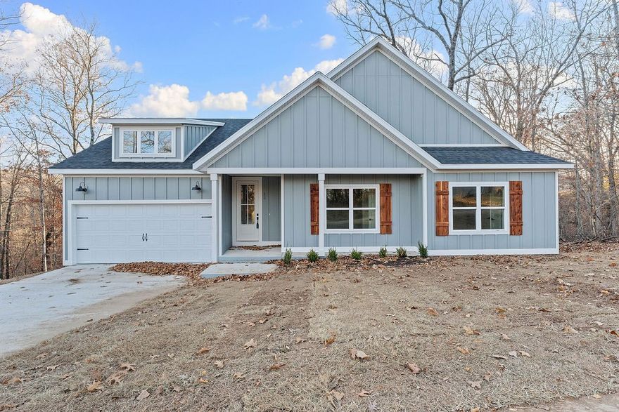 Access the back 40 trails from your backyard! This stunning home showcases 7" hand-scraped engineered wood floors throughout—including closets—and stylish tile in the laundry and baths. The inviting living area features an electric fireplace accented with shiplap for a modern, cozy touch. Enjoy the efficiency of Low-E double-paned windows and the elegance of custom cabinets topped with 3 cm Black Pearl granite throughout. The kitchen is a true highlight, featuring stainless steel appliances and sleek finishes. Black hardware adds a cohesive, modern look across the home. Step outside to a spacious back deck overlooking a gorgeous view—the perfect spot to relax or entertain. Complete with a 2-car garage, this home blends quality, comfort, and beautiful design in one perfect package!