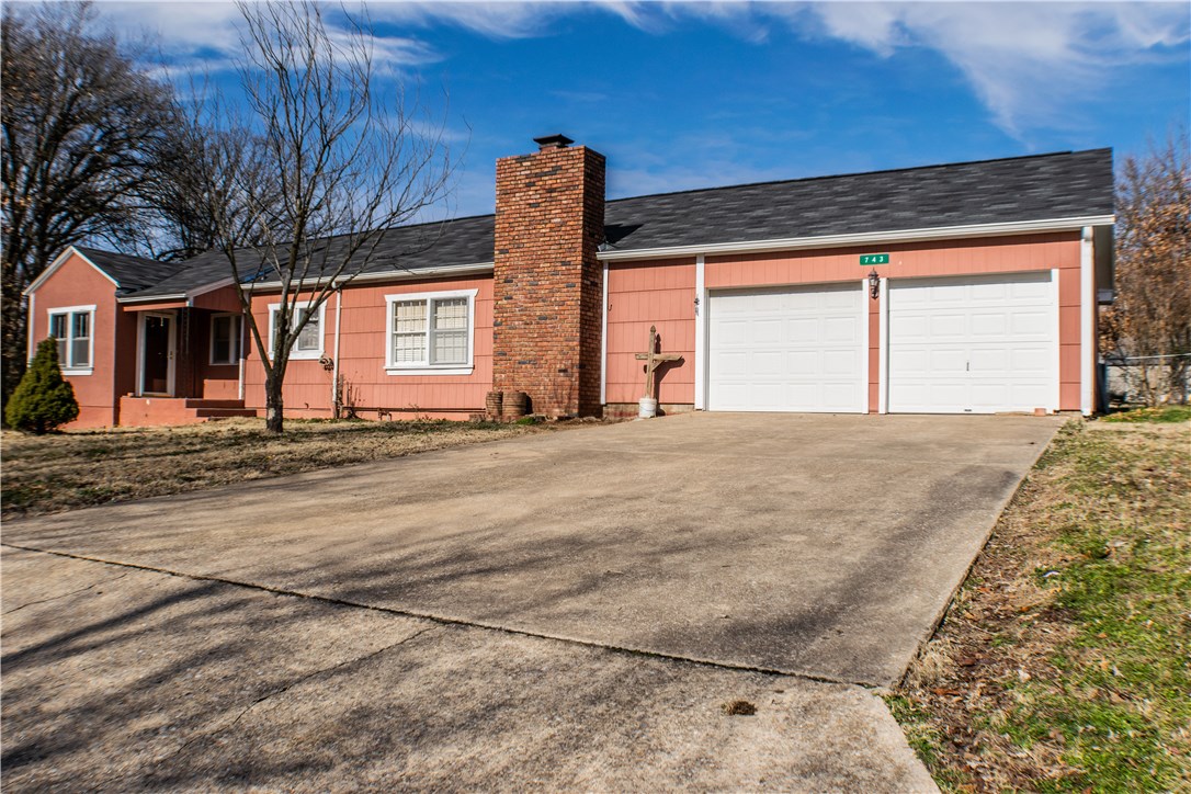 This wonderful home offers a new roof, new paint in all rooms, new heating and air unit, and brand new flooring in the kitchen, master, and living room. Has a double lot, big rooms, a two car garage, and a garden shed. This home has many different options with a potential 2 bedroom, 2 living room and 2 dining rooms set up. A fire place to stay cozy in the winter time and a patio out back for those beautiful evenings in the spring. Take this home and make it yours. Call today for more info.