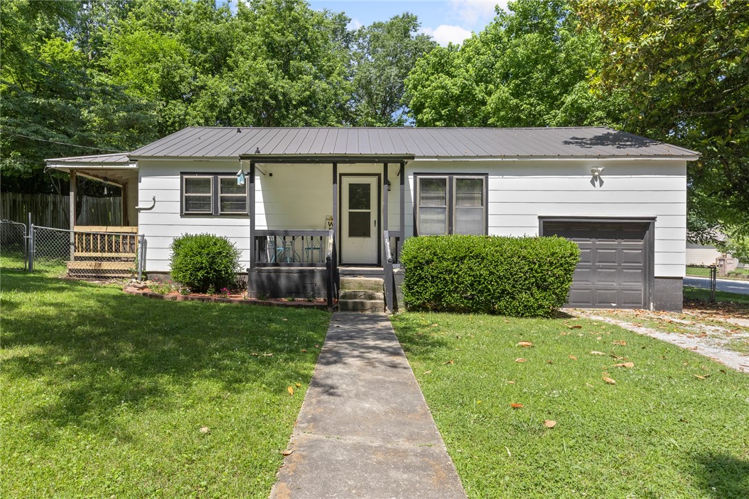 Charming 2 Bed, 1 Bath on Corner Lot – Ideal Starter or Investment Home! Located in the heart of Harrison, AR, this well-kept 2-bedroom, 1-bath home offers just under 1,000 sq ft of inviting living space on a roomy corner lot. Featuring a newer metal roof, updated kitchen with modern touches, and beautiful hardwood flooring throughout, this home is both stylish and functional. The fully fenced backyard provides a safe space for kids, pets, or outdoor entertaining. Whether you're a first-time homebuyer or looking for a solid investment property, this move-in ready home is a smart choice. Close to schools, parks, and local amenities—schedule your tour today!