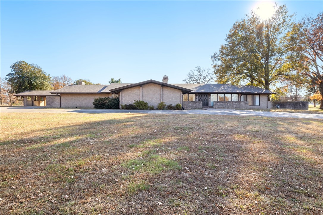 A home fit for entertaining with over 7,500sqft of interior space, large kitchen with island & tons of cabinet space, 2 living rooms, large laundry room, and an exceptional amount of natural light pouring in through the multitude of floor to ceiling windows! Throughout, you will find custom tile work & sinks, vintage wall decor, inviting oversized wet-bar, & stunning shiplap vaulted ceiling. Each bedroom offers a private ensuite and private patio. Enjoy outdoor living with expansive covered patio, private 80,000 gallon pool with diving board, & 1,200 sqft pool house complete with 2 bedrooms & one full bathroom. 30x60 shop building, with 2 10 foot automatic doors also offers approx. 500sqft of decked loft/mezzanine space. Roof and gutters were replaced in 2020. Agent is related to seller.