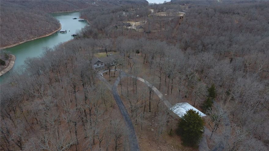 This mesmerizing Beaver Lake residence represents the pinnacle of upscale lakefront living, encompasses an entire point off Coose Cove and is a one of a kind 4,756 sqft, 5 bedroom lake home with lake views, over 450ft of shoreline, 5 acres and private dock, come see for yourself. Features include upgrades and updates throughout, formal living, secret room, office, open gourmet kitchen, great room, professional appliances, separate dining space along w/ multiple living spaces inside and out. Only 15 mins to Downtown Rogers, 25 mins to Wal-mart Hm Off, convenient and close but yet tucked away from the stress and noise of busy town streets! Call today and own you’re a little piece of heaven on Beaver Lake. Additional acreage available up to 65 acres. Call today!