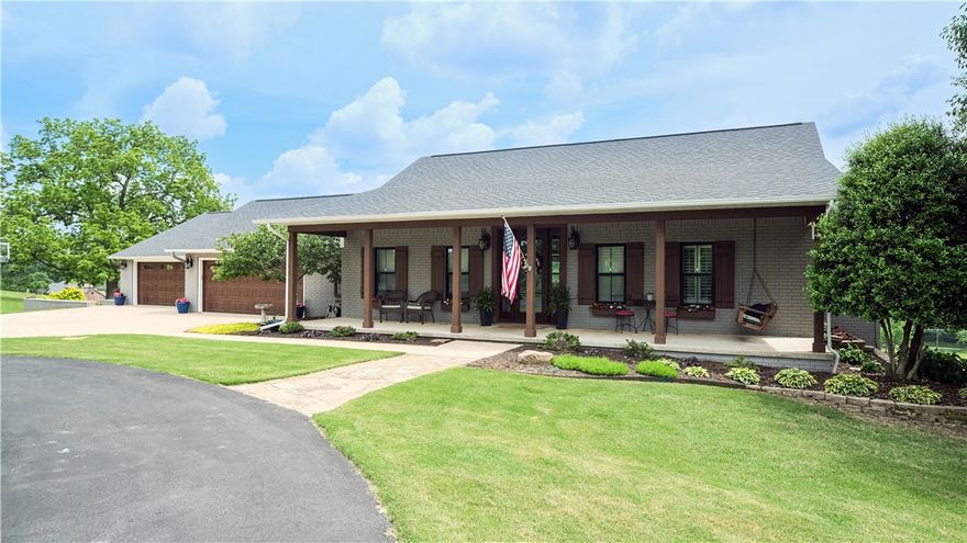 Welcome to 8249 Houdan Way! This remodeled home with a fantastic view is situated on 3+ acres and breathes attention-to-detail throughout. Step through the entrance onto the white oak floors and you'll be greeted by an abundance of natural light from the valley-view that fills this home. The fireplace alludes to cozy evenings while the kitchen boasts beautiful granite counters, and inset sink. The gas range will inspire your inner chef and just off of the kitchen, the mudroom reveals a wet bar, perfect for your guests. The light and airy views extend into the primary suite where the bathroom suite brings a spa-like experience with its free-standing tub and a double shower. Head downstairs to find ample family space as well as storage. An oversized four-car garage including shop space below rounds out the utility! This slice of the Ozarks lands you right by Bentonville AND Bella Vista bike trails. Don't miss the opportunity to own this beautiful home! Schedule your showing and see all that this home has to offer.