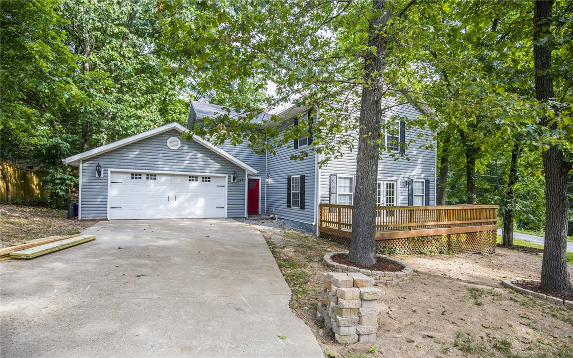 Come see this lovely family home right near Lake Windsor. Stunning real wood floors with beautiful inlays set this property apart. An open floor plan with large eat in kitchen and living room with gas firepace. Gorgeous seasonal lake views, close to Bella Vista's extensive mountain bike trails, Tanyard Creek, and all that Bella Vista has to offer for a family or a vacation rental property.