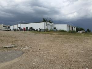 7.33 Acres M/L of Commercial Property on Hwy 62/412 with approximately 1330 ft of Hwy Frontage. Has a 6488 sg ft metal building with bay doors. Lots of room for several different types of businesses.