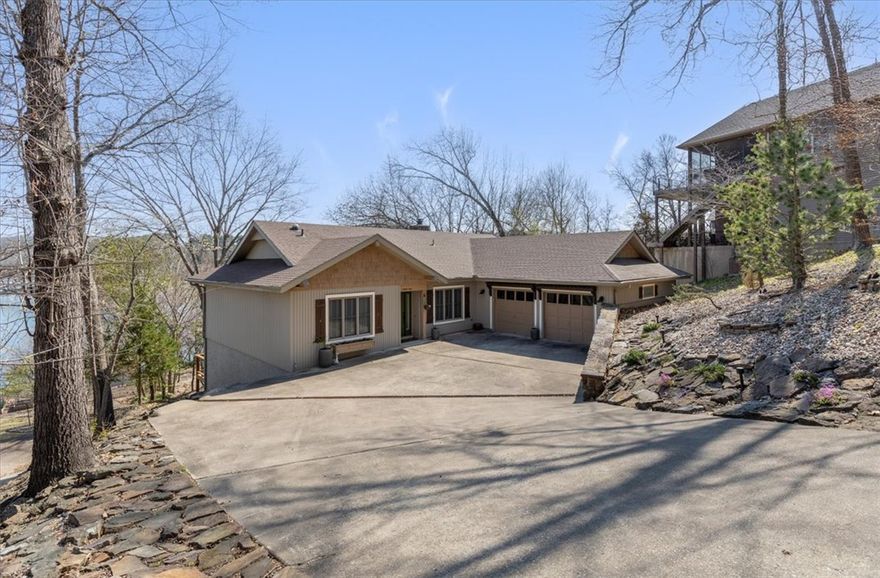 Your Lake Windsor dream home awaits! A MUST SEE!! Absolutely beautiful home -light & bright, updated, recessed lighting, gorgeous floors, a wall of windows in Living Room looking out to the lake, an uncovered deck, plus a covered deck area off Main bedroom, massive native stone fireplace in Living Room, separate Dining Room that also looks out to the lake, breakfast bar & pantry in Kitchen, Main Bedroom with beamed ceiling plus a built in closet & drawers & built-in open area for TV, Lots of cabinet storage in garage. Gentle manicured slope to boat dock, lake & a large seating area for entertaining your guests.  Yard features mature trees, grass, rock & native stone.  Stunning property!