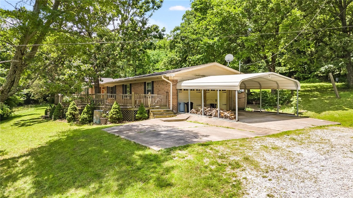 3/2 home on 3.4 acres. 30X40 Metal shop with electricity and 10' door! All brick home with updates, 2 living rooms + sunroom with skylights. Two decks off back of house, 33'x12'x33' with conveying hot tub & 11'x25, Wood-burning stove in main living room. Large deck off front 50'x20' with views to the East. Carport and additional pad for parking. 2 pantries, and updated electrical, plumbing, and interior.