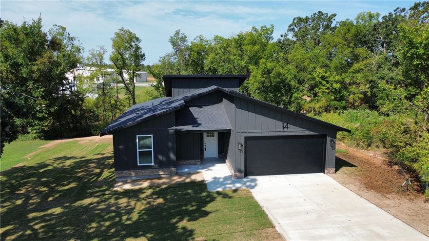This home features modern styling with an open living feel. This new construction 2 bedroom 2 bath home that includes an office/flex room comes with many upgrades. The home includes a large back deck for entertaining and overlooks the private back yard. The primary suite boasts a spacious bath with large closet and custom shower. Quartz countertops, custom cabinets and LVP flooring throughout. 10 year extended Quality Builders Warranty included.  All of this is located less than a mile from interstate access for ease and convenience to all of NWA.