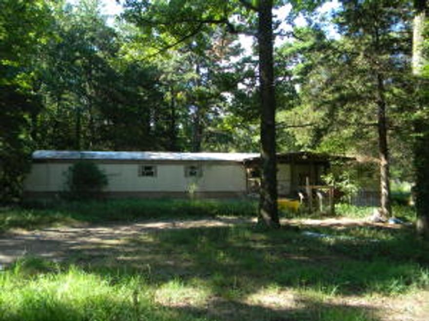 Priced to sell fast! Hunt from your own back yard! This single wide mobile home is located on 3 wooded acres in Russellville School district only minutes from town. Home is on permanent foundation with tie downs. Property being sold As-Is. (Call listing agent for access) NO VALUE WAS GIVEN FOR MOBILE HOME.