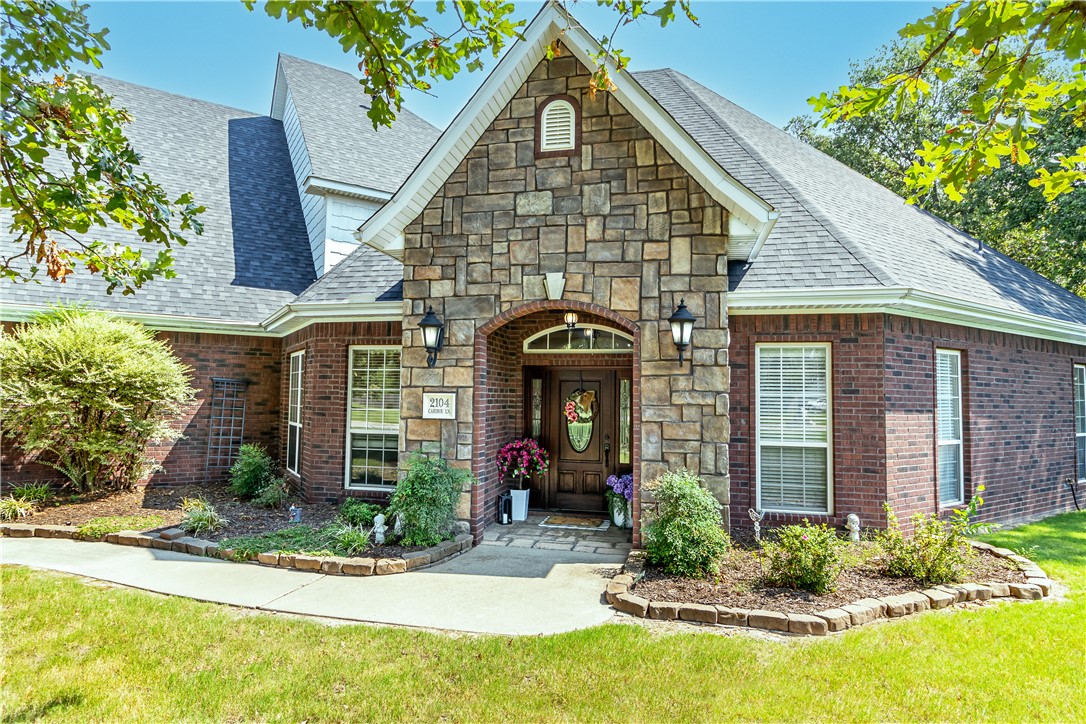 Beautifully designed 6 bedroom, 4 bath home on a picturesque 1 acre corner lot in Elm Springs. Perfectly positioned halfway between Fayetteville and Bentonville, this property offers both peaceful living and quick access to all NWA has to offer. Step inside to find a spacious primary suite featuring a soaking tub, walk-in shower, and an expansive walk-in closet. A second bedroom and full bathroom on the main level provide convenience for guests or multi-generational living. The inviting living room has built-in cabinets and a gas log fireplace. Enjoy formal gatherings in the dining room and work from home in the dedicated office. The upstairs has been recently renovated to include four generously sized bedrooms, two full bathrooms, a game room, and a bonus room. The home includes an attached 3 car garage plus a detached 2 car garage with attic storage. Outside enjoy two patios overlooking the large fenced backyard. One patio features a wood-burning fireplace, making it ideal for year-round entertaining.