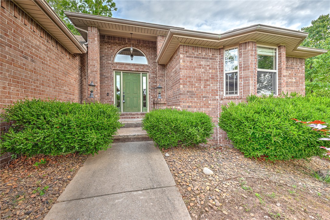 Nature lovers, golfers, and lake enthusiasts — this is the one you’ve been waiting for! Tucked in a prime Bella Vista location, this one-level home is just minutes from Scotsdale Golf Course, Branchwood Rec Center, and Loch Lomond Marina. The inviting layout is designed for easy living and features a spacious kitchen with a propane range, pantry, and eat-in dining area. The front room, with French doors, makes a perfect home office or guest room. The living room is large, and is complete with soaring cathedral ceilings, a propane fireplace, and rich engineered wood floors. Step out onto the covered back deck and take in the peaceful, wooded view. This home delivers the lifestyle you've been dreaming of.