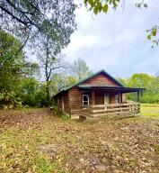 This Charming home features 2bedrooms, one bath. Just minutes from town this Cabin style home has so much potential. Eat in Kitchen and large laundry. Home is on a corner lot.