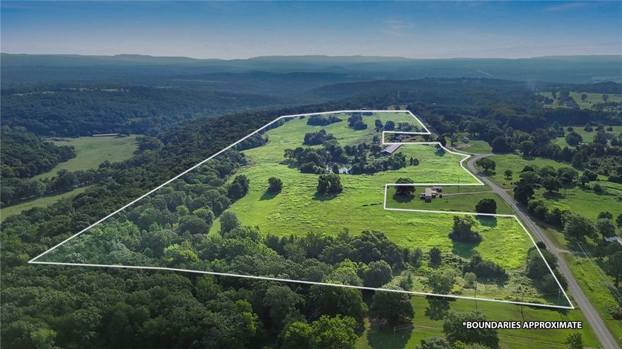 This exceptional 62-acre property features rolling terrain of mature woods and open pastureland. Strategically positioned on a corner lot.  Four scenic ponds and a running creek dot the landscape.  The varied topography and natural beauty make this land ideal for multiple uses - from recreational pursuits and potential agricultural ventures to subdivision possibilities for residential development.  The property currently features a cozy 1-bedroom main residence with 951 square feet of thoughtfully converted living space, and an additional 450-square-foot converted utility building added for space.  The combination of premium location, diverse natural features, existing infrastructure, and substantial acreage creates numerous opportunities for investors, developers, or those seeking a private estate with income potential. The corner positioning enhances accessibility while the water features and varied terrain add significant value for any intended use.