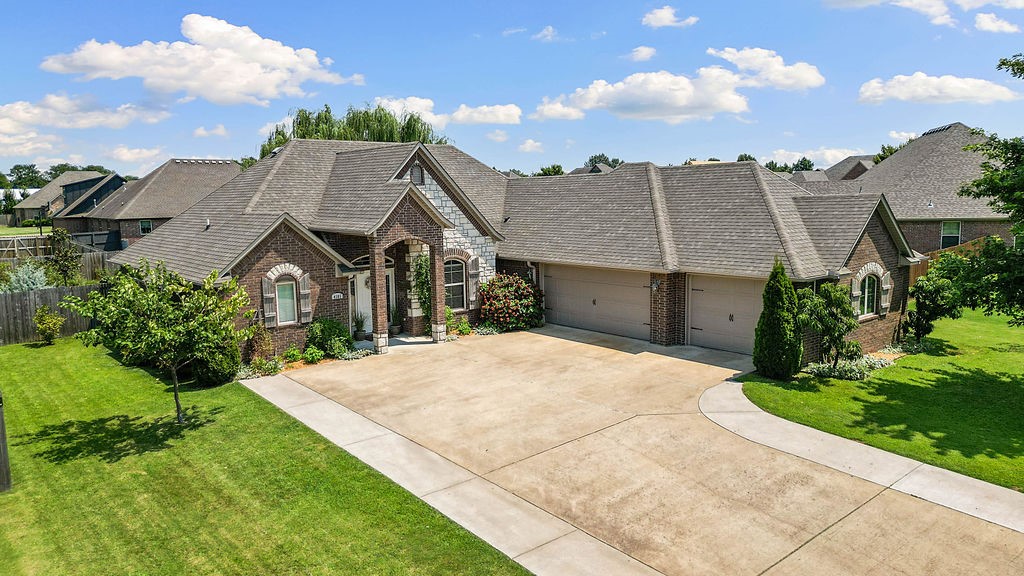 Entertain, garden, and relax in this NW Arkansas retreat! This well-maintained home features a split floor plan with vaulted great room, gas fireplace, formal dining, and a spacious kitchen with pantry, breakfast nook, and eat-at bar. The primary suite includes patio access, jetted tub, step-in shower, and a large walk-in closet. One of the other three bedrooms offers a walk-in closet that doubles as a concrete-reinforced storm shelter and safe room for your peace of mind. Enjoy the covered patio with brick gas fireplace, retractable movie screen, extended seating area, and raised garden beds. The backyard is filled with native, edible, and herbal plantsāKentucky wonder beans, tomatoes, blackberries, grapes, elderberry, mint, and lambās ear. A courtyard-style driveway and 3-car garage provide ample parking. The front door faces west; garage doors face north. Community pool, playground, and trails! Seller offering $5,000 credit toward carpet replacement, closing costs, or interest rate buy-down ā buyerās choice.