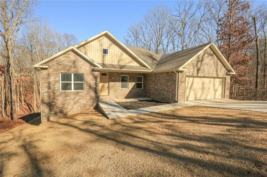 Be only the second tenant to live in this gorgeous 1 year old home in East Bella Vista. The 3 Bedroom, 2 Bath, sits on a quiet dead end street, with nice cleared and sodded back yard all the way around. The home has an open concept with the kitchen, dining and living room all flanked by a cozy fireplace. Granite counters and all appliances including Refrigerator. Close to the Back 40 Trail system and only minutes into Pea Ridge, Town Center or easy access to the Jane retail district. Don't wait long if you are looking for a newer construction to lease with modern finishes and upgrades.  Enjoy the peace and quiet of being in the middle of nature and also currently neighbor free.