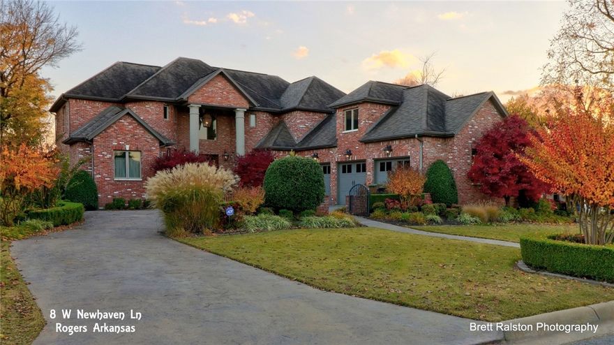 Stunning sunlit rooms in this beautiful 5BR, 5.1BA three story home in Pinnacle Country Club, Rogers, AR. Fifth BR could be in-law suite.  Refinished wood floors, new master bath with soaking tub. New dishwasher, double Wolf convection ovens, quartz counters.  Lower level has bonus room with wet bar, tons of sunlight, game room, extra room being used for 6th bedroom.  Three car garage.  Storage everywhere.  Lots of updates in this fresh and bright home!