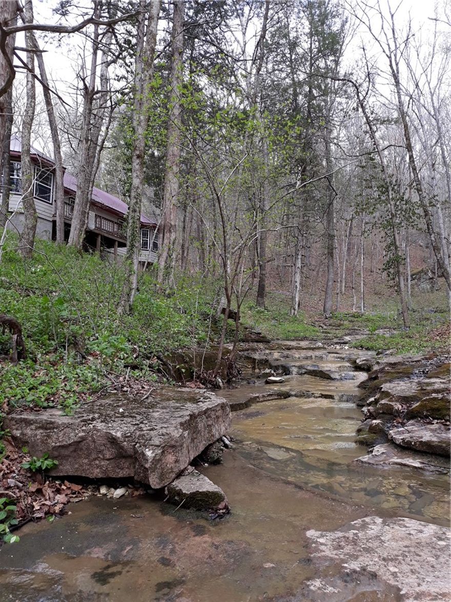 Very private and secluded setting for this home with 3 BR, 2 BA, 2,056 SQFT, and on 4.97 Acres M/L. The home features an open floor plan, wood stove, bay windows, wood and tile flooring, walk-in closets, cathedral ceilings, and much more.  The land features include a 10 x 16 storage building with electric, 24 x 24 metal barn, 12 x 12 wood shed, seasonal creek, large hardwood trees, close to a paved road, and close to Henson creek.  The property sits in the valley with tall Ozark Mountains surrounding the home.  Close to the Buffalo National River Park and National Forest.  This is a must see home.  Call today to schedule a showing.