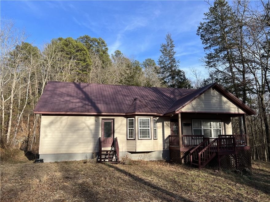Very private and secluded setting for this home with 3 BR, 2 BA, 2,056 SQFT, and on 4.97 Acres M/L. The home features an open floor plan, wood stove, bay windows, wood and tile flooring, walk-in closets, cathedral ceilings, and much more.  The land features include a 10 x 16 storage building with electric, 24 x 24 metal barn, 12 x 12 wood shed, seasonal creek, large hardwood trees, close to a paved road, and close to Henson creek.  The property sits in the valley with tall Ozark Mountains surrounding the home.  Close to the Buffalo National River Park and National Forest.  This is a must see home.  Call today to schedule a showing.