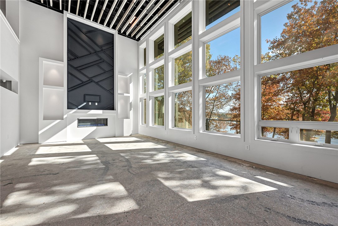 Pursue endless possibilities on this private estate with breathtaking Beaver Lake views and direct water access. This property is ideal for unique commercial use, including weddings, corporate retreats, wellness getaways, or boutique hotel. The remodeled, light-filled building boasts top-of-the-line custom features, including an exquisite ceiling, energy-efficient Anderson windows, expansive decks, a new roof, and HVAC system. Designed for commercial or residential use, it includes essential features like sprinkler system and specialized doors, with zoning permitting diverse opportunities. Additional features are in the attachments. With over 7 acres, there are multiple building sites for development, gardens, and more, plus a 1,800 sq. ft. building with lake views that can be transformed into an art studio, gym, guest house, or office. A stable provides space for equestrian needs. Conveniently located just of 412, this property blends luxury, natural beauty, and accessibility.