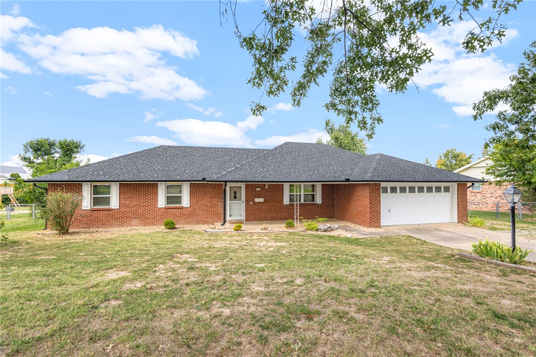 Fully Renovated Rogers Home! Located on a quiet street with easy access to Downtown Rogers & Pinnacle Area Shopping/Dining/Entertainment. The home features an open layout with 4 bedrooms, a sunroom, and a large 720 sq ft shop building. New Paint & Flooring throughout. Entry has double closets & leads into living room. Living room boasts a beautiful brick wood burning fireplace and is open to the eat in kitchen, great for everyday and for entertaining. A second living space offers a great formal living room area, or dining space, or media room space. The kitchen has a great layout, including a butcher block island, custom vent hood, soft close drawers & leathered granite counters. Large laundry off kitchen has storage space for pantry area. Sunroom is enclosed and has window unit, great craft room or office. 3 guest beds and guest bath. Primary has dual closets and attached bath with beautiful tiled shower. Updates include new roof, windows, HVAC, Water Heater, Doors, Trim. Move in Ready, Welcome Home!