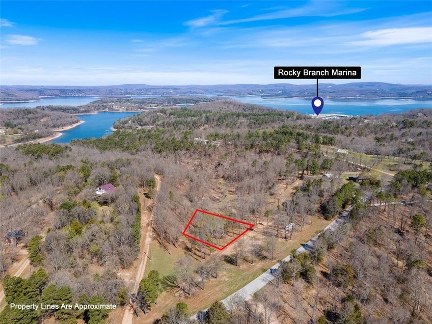 Plant yourself in a cabin down in this half acre lot in the Rocky Branch Resort area. Electric nearby with municipal water at Rocky Branch Road. About a mile and a half from swimming area and public boat launch at Rocky Branch State Park and Marina. Nearby Hobbs State Park hiking and biking trails, War Eagle Mill and Caverns. Additional lots available.