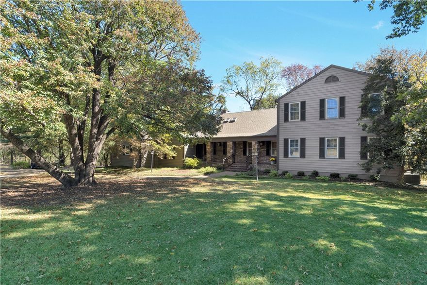 Looking for your dream home in East Fayetteville neighborhood? This home is very well maintained. House sits on a beautiful tree covered 2.08 acre lot. The kitchen opens up into the family room, dining and living room. The doors in the kitchen and living room open up to a beautiful screened in porch with cathedral ceilings and amazing views of the White River Valley. This area is perfect for entertaining family and friends. The 912 sq ft basement would make a great bonus room. The half bath in the basement can be used as a storm shelter. The third garage is for riding lawn mower and provides an extra storage area. Primary bathroom has a laundry shoot and heated floors. Community amenities include a heated pool and tennis court for your families enjoyment. This home will not last long. Refrigerator in kitchen will convey.