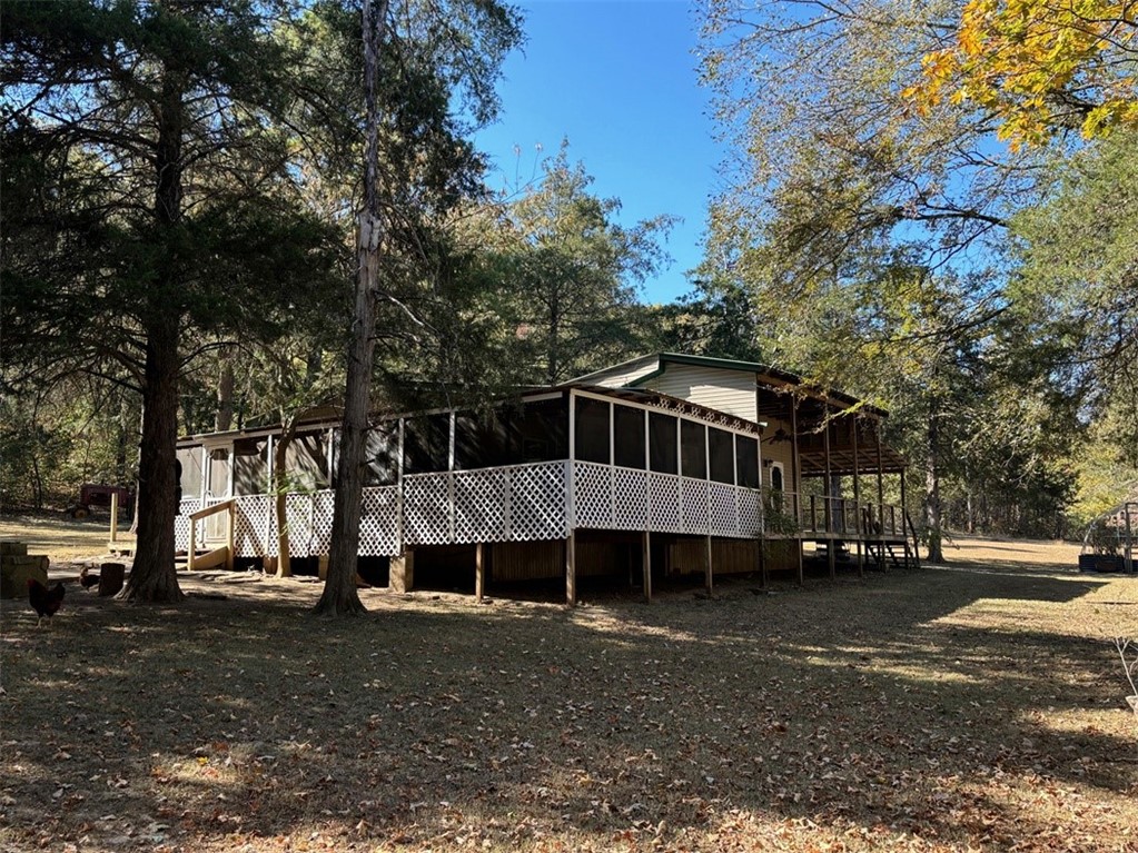 Get away from most everything with this unique 2 BR home on 12 acres, seasonal creek frontage, wooded homesite, outbuildings for tinkering or storage, screened in deck, and wildlife abundant makes this an attractive Ozark get away or permanent residence. Inside accommodations include a pretty kitchen with Corian counter tops, bath with walk in tub, wooded floors, sunroom, and vaulted ceiling in large living room. 40 minutes or less to Branson, Bull Shoals, Table Rock, and Taneycomo Lakes, White River, and numerous hunting, camping, and sightseeing venues.