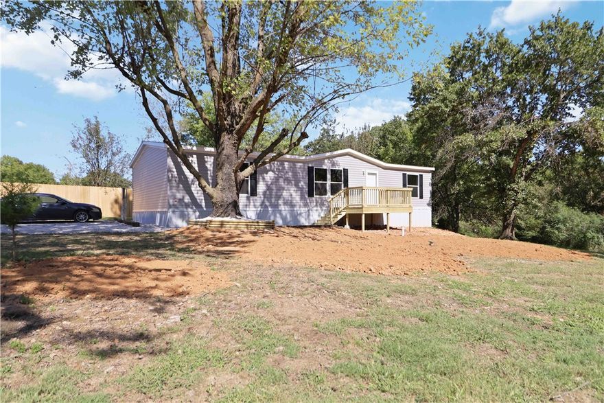 Welcome to this exceptional opportunity to own a brand new manufactured home nestled on 0.62 acres just 10 minutes to town. This double-wide home is on a permanent foundation with 1,493 square feet and a great split floorplan design. Key details 3 bedrooms, 2 full bathrooms, kitchen island, vinyl flooring throughout, front and back decks, gravel driveway, and outbuilding great for storage. The country setting offers privacy for those not wanting to live in subdivisions! Biggest bonus is this double-wide is brand new and ready to be called a home! Close to Beaver Lake and perfect for outdoor enthusiasts. Existing septic tank has been pumped and HUD Compliant Foundation Engineering Certification is available for financing purposes.