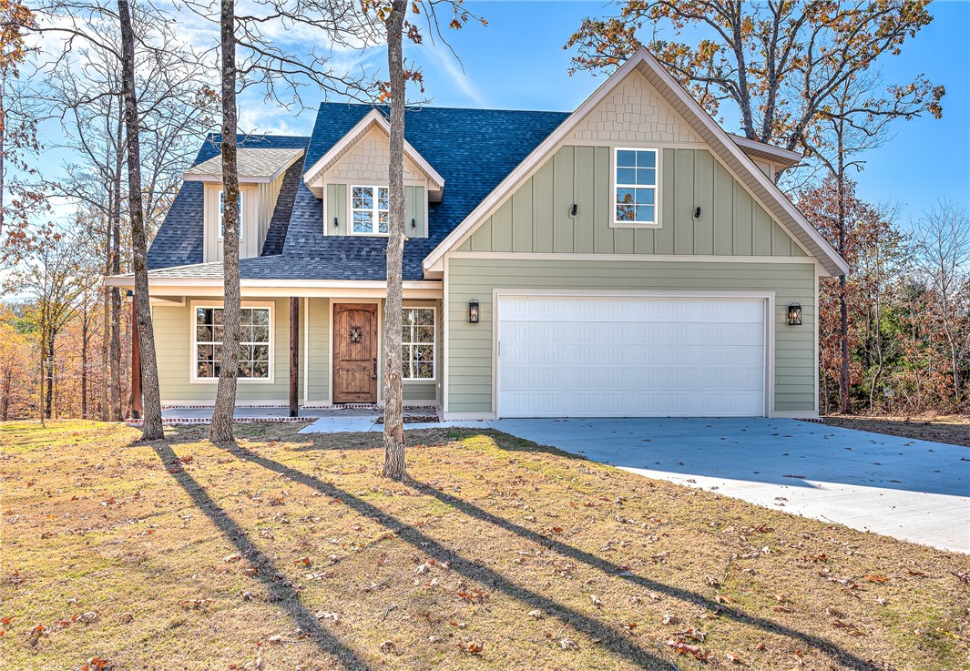 This stunning 4-BR, 4-BA custom home in Bella Vista sits on a 0.86-acre lot surrounded by mature trees. At just under 3,000 sqft this home features walnut hardwood floors, vaulted ceilings with custom wood beams, and a real wood fireplace. The open-concept living area is flooded with natural light and flows into the chef’s kitchen, complete with granite countertops, shaker-style cabinetry, recessed lighting, and stainless steel appliances.The formal dining room, with custom coffered ceilings, overlooks the large, flat, usable backyard. The master suite offers a spa-like retreat with a stand-alone tall bathtub, custom-tiled walk-in shower, dual vanities, and a walk-in closet. Three spacious bedrooms provide ample room for family & guests. Upstairs, a versatile bonus room is perfect for a media room or game room.Located within 2 minutes of Highlands Golf Course, minutes to Lake Loch Lomond and Branchwood Rec Center, easy access to I-49, this home offers the perfect combination of luxury, location, and functionality.