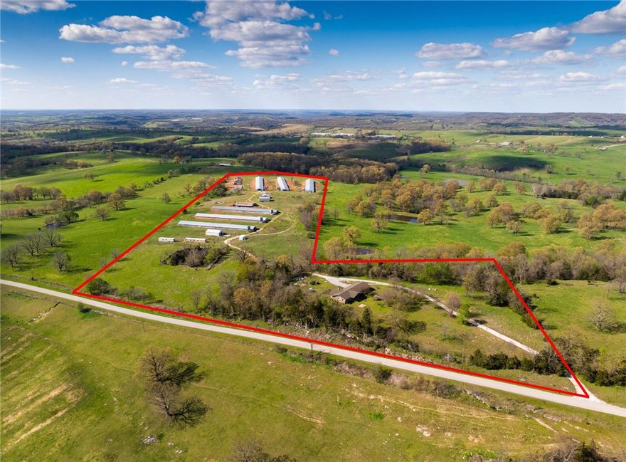 This 34-acre property offers panoramic 360° views of the rolling Ozark Mountains and is perfectly positioned just 20-25 minutes from Branson, Missouri and only 15 minutes to Harrison, Arkansas. With easy access to Highway 65, you can enjoy country living with the convenience of nearby towns.

The property features a main home that’s ready for a remodel and your personal touch, along with several older mobile homes that could be renovated for extended family, guests, or income potential. There are also poultry barns on site—while there are currently no active contracts, the space offers a range of agricultural or storage possibilities.

A unique highlight, the former rock quarry, now transformed into a peaceful fishing pond with unforgettable views—perfect for relaxing or spending quality time outdoors.

Whether you’re looking for a private homestead, a small hobby farm, or investment potential, this property offers endless possibilities.