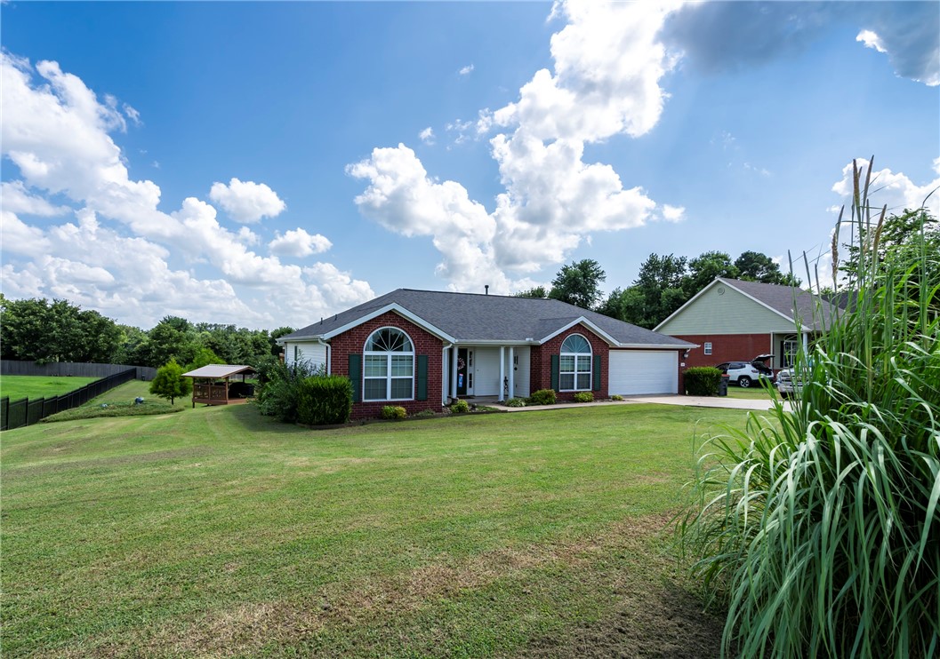 Located in the heart of Cave Springs, this home offers a comfortable living room with a gas log fireplace and a bright kitchen featuring white cabinets, matching appliances, and a bar top for extra seating. Just off the kitchen, you'll find a high-ceiling office with a unique half-moon window and additional access from the front door. The split floorplan includes a formal dining room or sunroom that opens to a newly added covered back deck. Outside, enjoy a second covered grilling deck, a chicken coop, storage shed, and a backyard with plenty of space. A storm shelter just steps from the door adds peace of mind. Recent updates include a new water heater and roof and gutters replaced in 2019. Gas is available in the kitchen if preferred over the current electric stove. Conveniently located near dining, shopping, and parks with easy access to all of Northwest Arkansas .
.