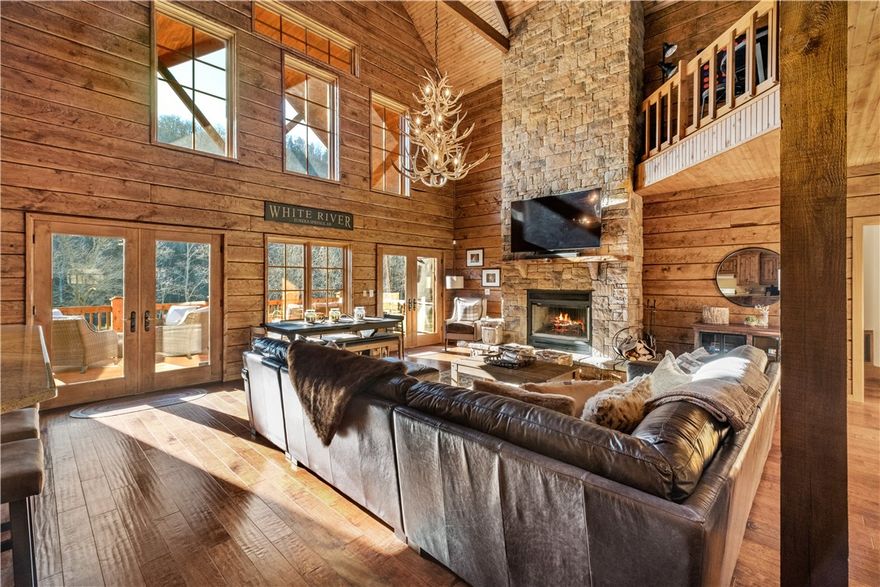 Luxurious, river-front log cabin on over 4 ½ acres! Located between Rogers & Eureka Springs- 5 minutes from Beaver Dam. Kayakers, Trout fishermen, and outdoor enthusiasts will enjoy this enchanting river-front cabin on the White River. Launch kayaks into the gently flowing river from the banks of your property. This serene retreat offers a rustic yet luxurious log cabin with 3 beds, 2 ½ baths, a bunk loft, an outdoor shower, a fish cleaning station, covered wrap-around porches, 2 screened porches, a riverside fire pit, a detached garage & a park-like setting. The warm & welcoming living area offers soaring ceilings, an open floor plan, a wood-burning fireplace & oversized windows allowing natural light to stream in. Nearby towns offer a variety of entertainment: Eureka Springs (9 miles), Rogers ( 27 miles), and Bentonville (29 miles).  Multiple mountain biking trails, including Lake Leatherwood Gravity Project ( 6 miles) nearby. This well-maintained property is currently a highly rated, income-producing AirBNB.