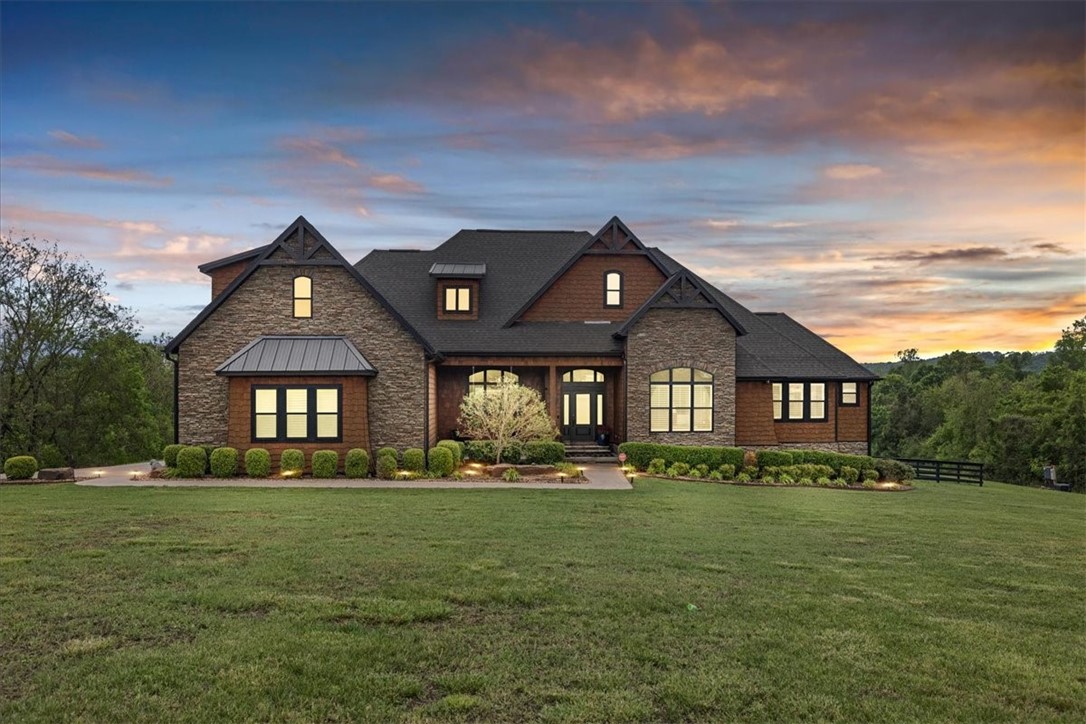 Exquisite estate nestled on 13.44 private acres in Goshen, just minutes from Fayetteville. Spanning 5,000 sqft, this stunning home features five bedrooms and four bathrooms, showcasing craftsmanship from superior construction to luxurious designer finishes.
Enjoy breathtaking landscaping accentuated by natural Arkansas rocks, unwind in the hot tub under the stars, or host memorable gatherings at the outdoor kitchen. Movie nights are a breeze in the private theater room. The interior boasts professional-grade appliances, custom cabinetry, granite countertops, and premium details throughout.
Additional highlights include a spacious 40x60 shop with dedicated living quarters and two 50-amp RV hookups, perfect for hobbies, storage, or guest accommodations. This remarkable property offers a perfect blend of privacy, luxury, and versatile outdoor living in a peaceful rural setting close to Fayetteville. List of upgrades attached.