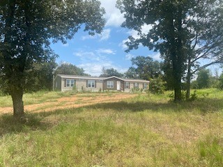 Manufactured home on 17.93 acres. Located outside of town, rural setting yet easy access to amenities. Home has 4 bedroom 3 baths, c/h/a, nice kitchen, living room, large pantry/storage room and utility room with sink and cabinets. The master bedroom has a sitting area perfect for office, nursery and other uses. The master bath has soaking tub, separate shower, toilet closet, two vanities and walk-in closet. Land is open around house with remaining area mostly wooded.
