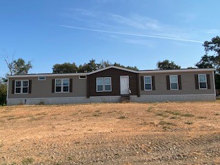 Manufactured home on 17.93 acres. Located outside of town, rural setting yet easy access to amenities. Home has 4 bedroom 3 baths, c/h/a, nice kitchen, living room, large pantry/storage room and utility room with sink and cabinets. The master bedroom has a sitting area perfect for office, nursery and other uses. The master bath has soaking tub, separate shower, toilet closet, two vanities and walk-in closet. Land is open around house with remaining area mostly wooded.