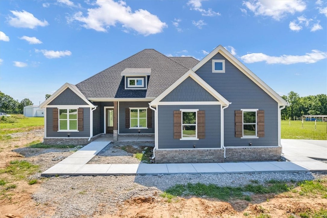 Escape the ordinary with this stunning new construction on 2.18 peaceful acres in Magnolia Ridge. Step into an inviting living room flooded with natural light and soaring vaulted ceilings that create a spacious, airy ambiance perfect for both relaxing and entertaining. The gourmet kitchen boasts an oversized island, premium countertops, and ample cabinet space—ideal for family meals and culinary creativity. The main level also offers three generously sized bedrooms, including a luxurious master suite designed as a private retreat boasting a large walk-in closet and a spa-inspired bathroom with dual vanities, a soaking tub, and a separate shower. Upstairs is versatile fourth bedroom with its own full bath, perfect for guests. A dedicated office on the main level provides a quiet workspace to meet today’s needs. Blending upscale finishes with thoughtful design, this home offers a peaceful lifestyle with easy access to Fayetteville’s amenities—a perfect balance of country living and city convenience.