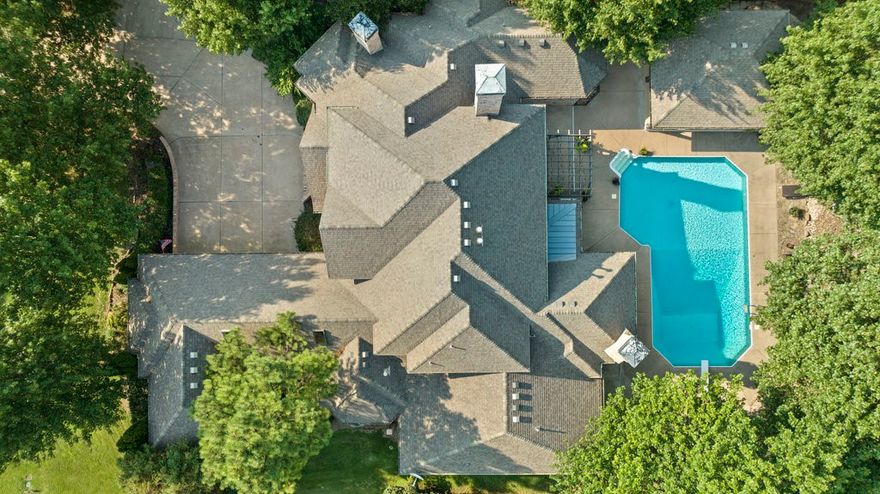 Indulge in luxury with this Stunning 4 bed, 4.5 bath Estate in esteemed Thornbury. Nestled on .6 acres, this home boasts a heated pool and a heated/cooled pool house, creating a private outdoor oasis perfect for entertaining and unforgettable moments. NEW hardwood floors, granite countertops, HVAC, and roof. Elegant 2-story formal living room features a fireplace and floor-to-ceiling windows, while a second fireplace graces the den with integrated built-ins. Chef's kitchen, complete with dual ovens and a central island, is ideal for culinary enthusiasts. Owner's suite offers a sitting room, a private bath with a walk-in shower and jetted tub, and a lavish custom-designed closet. Additional features include an office, versatile bonus room, playroom, and an open floor plan with 3 main-level bedrooms, one with handicap-accessible amenities ensuite bathroom with a roll-in shower. Embrace gracious living and effortless entertaining, with convenient access to a neighborhood park, greenway, and all that NWA has to offer!