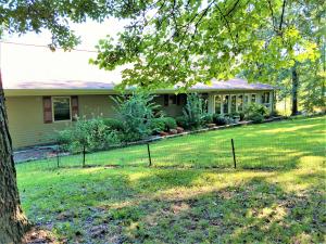 $7500.00 allowance added for paint, floorcovering, deck and driveway maintenance!!Beautiful park like setting for this spacious home with year round Crooked Creek ! 10 wooded acres above Crooked Creek, just minutes from town.!3 bedroom, 2 baths on the main level, plus a full basement with family room, kitchen, bedroom and full bath, a great set up for teens or MIL quarters!The roof is only 3 yrs old and the home also features granite counter tops, 22 k Generac generator, beautiful high end vinyl plank flooring. Covered front porch and gorgeous sunroom. Workshop in the basement could be finished for more space if needed. 10 acres m/l plus beautiful Crooked Creek,on the edge of town. Seller is offering 7500.00 allowance for floorcoverings, deck maintenance, paint, driveway repair.