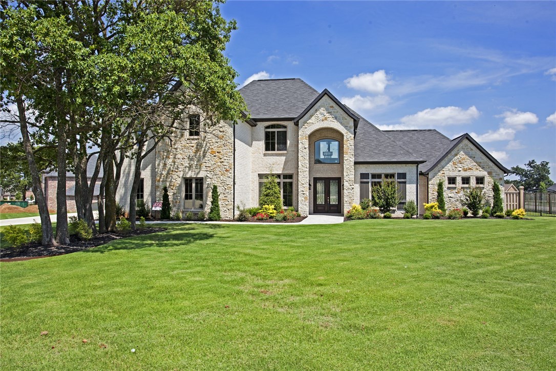 Payne Construction masterpiece... Estate home on 1.73 acres, 4 car garage, large bedrooms w/walk-in closets, bonus rm and media rm w/ built in wet bar. Second master suite on main level w/own bath and garage access. All the features you want including wine room, home audio, central vac, Jenn Air appliances w/a 6 burner cooktop w/griddle and double ovens. Covered back patio w/Fireplace and built in grill. Huge fenced yard. Gated community w/pool, 1 mile from Elem & Bentonville West High school.