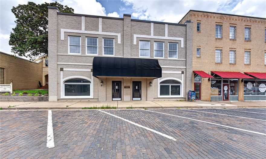 Position your business for success with this standout 11,600 SF office building in the heart of Rogers Historical Downtown. This 11,600 SF two-story office property delivers the kind of space that elevates your operations the moment you step inside. From expansive office layouts to high-end wood finishes, every detail reflects quality, functionality, and professionalism.
Natural light fills the building, creating a bright and inviting work environment across both levels. The flexible layout features large offices throughout, offering the perfect balance of privacy and collaboration. The roof was replaced in 2025, providing added value and peace of mind. An additional lot with six parking spaces is included- offering additional investment opportunities; i.e food truck? Keep the charm and history or re-invigorate the space as an upscale office building, or reimagine into boutique hotel, wellness clinic or so much more.
Bottom line: this isn’t just office space—it’s a strategic investment in your business’s future.