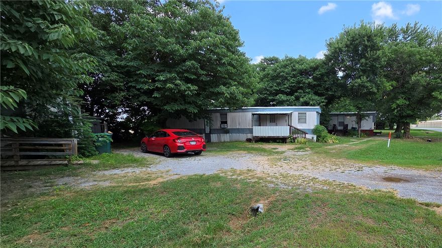 Great rental income from three mobile homes that stays rented. There is a fourth mobile home on property could be hooked up & rented for additonal income.