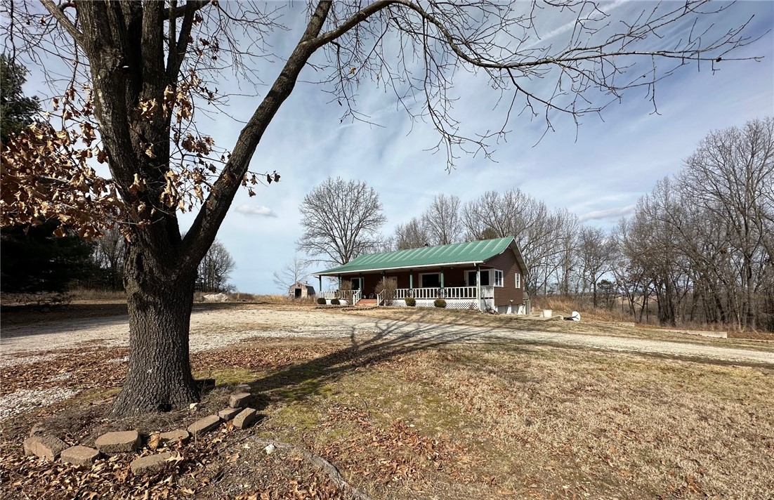This two bed with bonus room and 2.5 bath has nice country setting and approximately 15 acres m/l. Lots of wildlife and the ideal place to raise a family. Spacious garage leads into approximately 300 sq. ft of basement. There is a safe room off the garage. Modern kitchen, updated in 2017 New CH&A 2022, and new water heater 2021. More photos to follow. Property is gated. House has security cameras privately owned