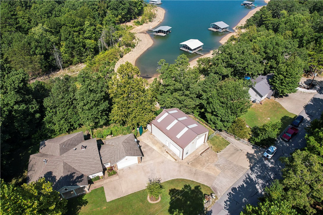 Lakefront property looking for the perfect family to call it home! Enter inside to a spacious living room w/wood burning fireplace for those chilly nights. The efficient kitchen is the perfect space to prepare breakfast before walking out to the covered back deck to enjoy the morning while overlooking gorgeous Beaver Lake. The 3 bed/2 bath offers plenty of room for your growing family & w/some updated paint & flooring, this home will be perfect. New Heat & Air installed in Aug 23, along w/new well pressure tank & components. The backyard is fenced for your fur babies & also has a nice garden area that is protected from the deer. The house & shop sit on 2 lots equaling .66ac & touch the Corps line so easy access down to the water & enjoy those hot summer days w/o leaving your property. Did I mention the shop? This 30x40 shop has 2 oversized doors, loft for storage, & a full bath to clean up before going inside. Plus a fenced area to park your trailers! And w/a neighborhood boat ramp, you never have to leave!