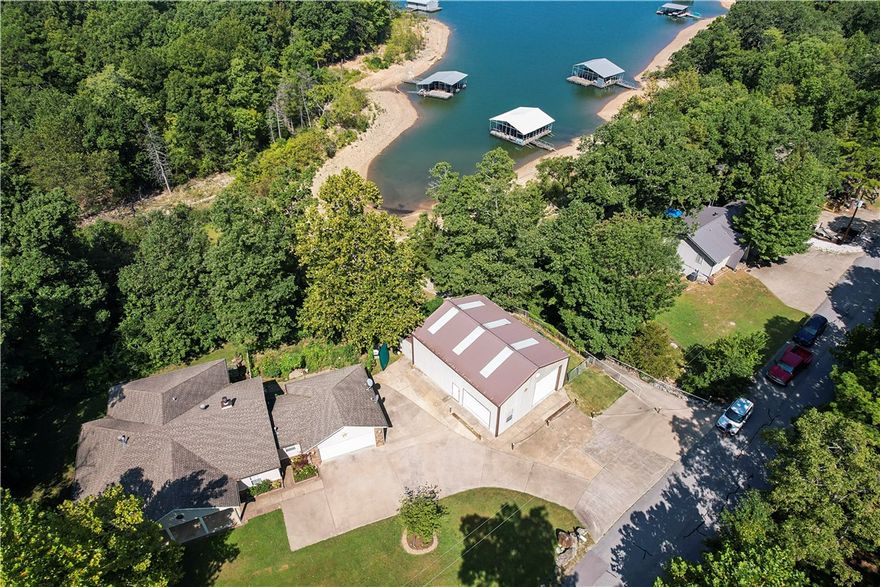 Lakefront property looking for the perfect family to call it home! Enter inside to a spacious living room w/wood burning fireplace for those chilly nights. The efficient kitchen is the perfect space to prepare breakfast before walking out to the covered back deck to enjoy the morning while overlooking gorgeous Beaver Lake. The 3 bed/2 bath offers plenty of room for your growing family & w/some updated paint & flooring, this home will be perfect. New Heat & Air installed in Aug 23, along w/new well pressure tank & components. The backyard is fenced for your fur babies & also has a nice garden area that is protected from the deer. The house & shop sit on 2 lots equaling .66ac & touch the Corps line so easy access down to the water & enjoy those hot summer days w/o leaving your property. Did I mention the shop? This 30x40 shop has 2 oversized doors, loft for storage, & a full bath to clean up before going inside. Plus a fenced area to park your trailers! And w/a neighborhood boat ramp, you never have to leave!