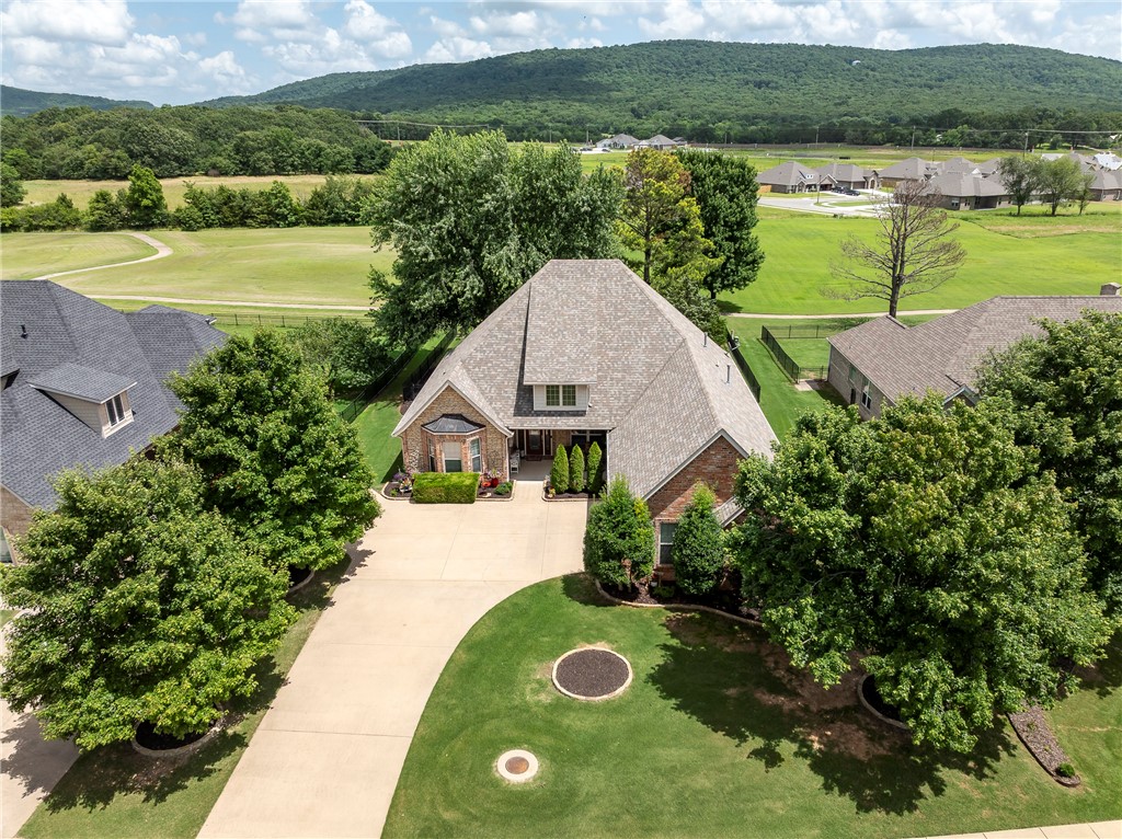 One level home with gorgeous outdoor living space and mountain views. Eat-in kitchen with gas cooktop, in-wall oven/microwave, pantry. Rich woods used throughout give this home a cozy feel. Huge vaulted living, formal dining, 4 BRs, 2 BA split plan, extra storage. Big covered patio & porch. Enormous shaded deck overlooking the mountains and common area with walking path behind just outside of the iron fence. Oversized garage w/extra bay/door for golf cart or mower.
