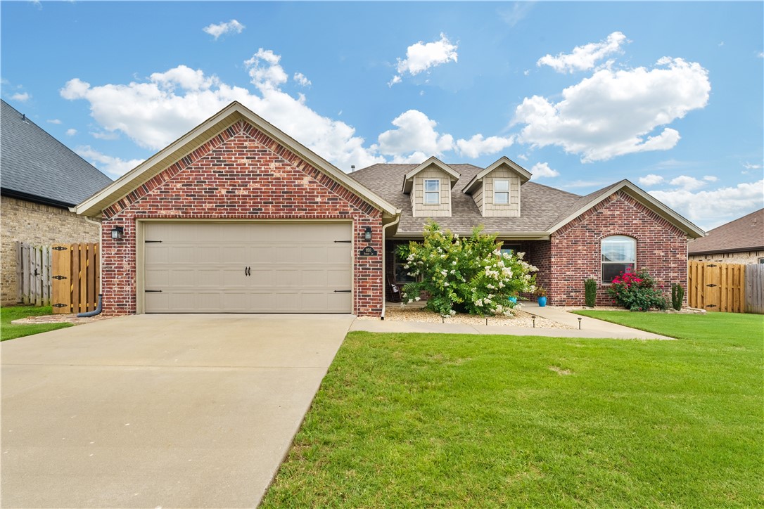 Welcome to Sunrise Ridge! This charming home features soaring ceilings, a double-sided fireplace, and a spacious split floor plan ideal for comfort and style. The kitchen is a dream with granite countertops and beautiful wood beams throughout kitchen/ dining, and living room to add an elegant touch. Step outside to enjoy the beautifully landscaped yard, a 7x16 custom pergola, and an 8x16 shed for added storage. The fully fenced yard includes a covered back deck with two standing planter boxes—perfect for entertaining or relaxing. Fresh paint throughout and an insulated garage door complete this well-maintained gem. Just 5 minutes to I-49, 14 minutes to Downtown Bentonville, and 20 minutes to Walmart HQ. Located near Bentonville's top-rated schools! Schedule your showing today!