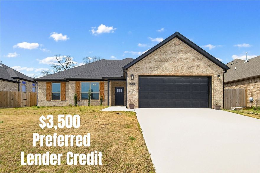 Stunning Single-Story Brick Home with Designer Finishes! - From the eye-catching curb appeal to the beautifully designed interior, this home has it all. The kitchen features ceiling height white shaker cabinets, quartz countertops, subway tile backsplash, a large center island, and premium stainless steel appliances including a GE Profile gas range. The open living area impresses with vaulted ceilings and a cozy herringbone tile fireplace.
The spa-like primary bath offers a dual-sink vanity, glass-enclosed walk-in shower, and a deep soaking tub. Additional bedrooms are generously sized with plush carpet and ceiling fans. Secondary baths carry the same refined aesthetic with quartz vanities and matte black fixtures. Wide-plank engineered hardwood floors, recessed lighting, and brushed gold accents flow throughout. The spacious two-car garage and charming brick exterior complete this stunning, move-in ready gem — schedule your showing today!  Up to $3,500 preferred lender credit!